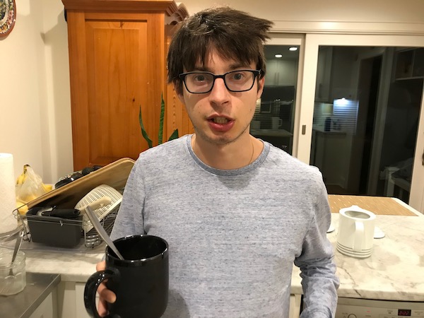 Young man holding mug