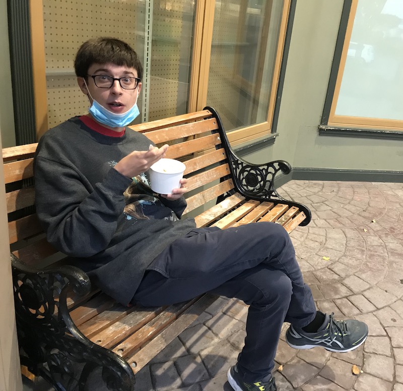 Man sitting on a bench and eating ice cream