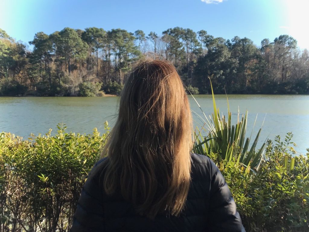 Woman looking out onto a body of water
