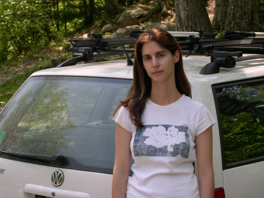 Woman standing in front of a white car
