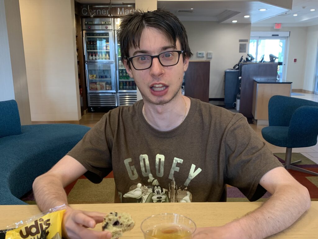 Young man eating a muffin