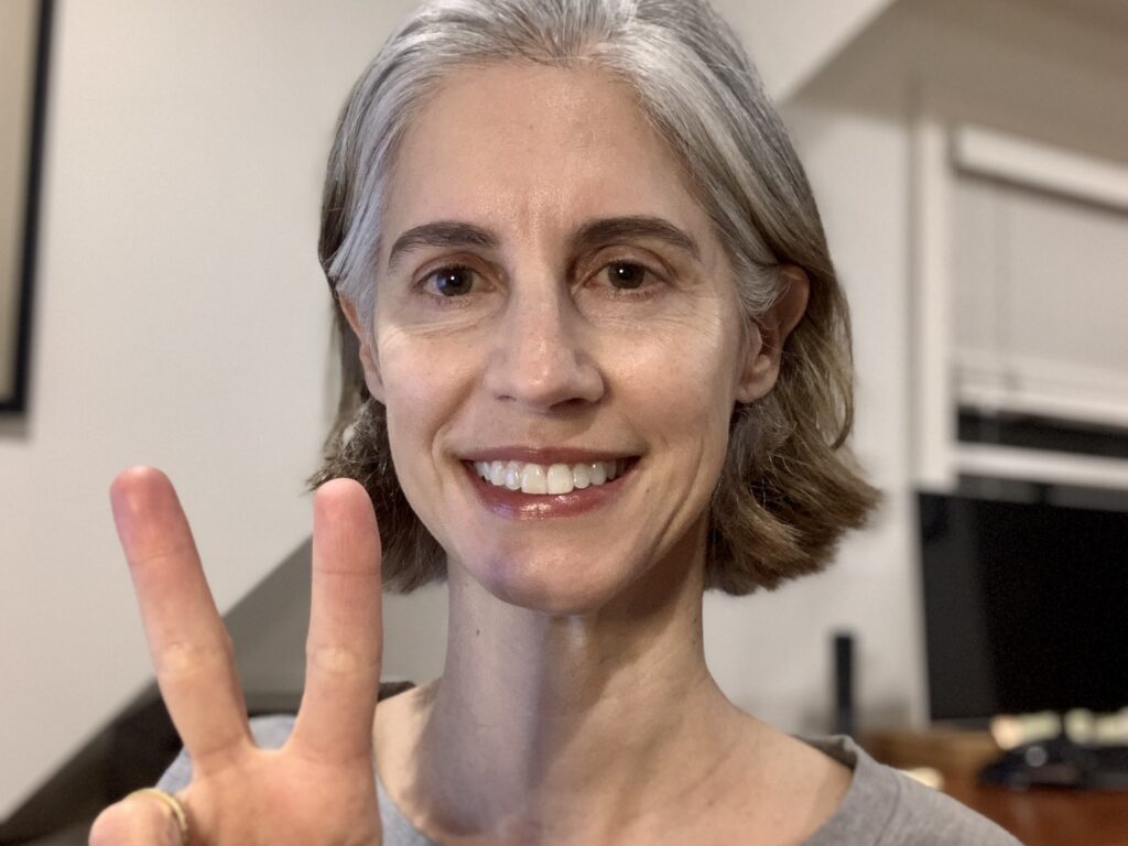 woman holding peace sign