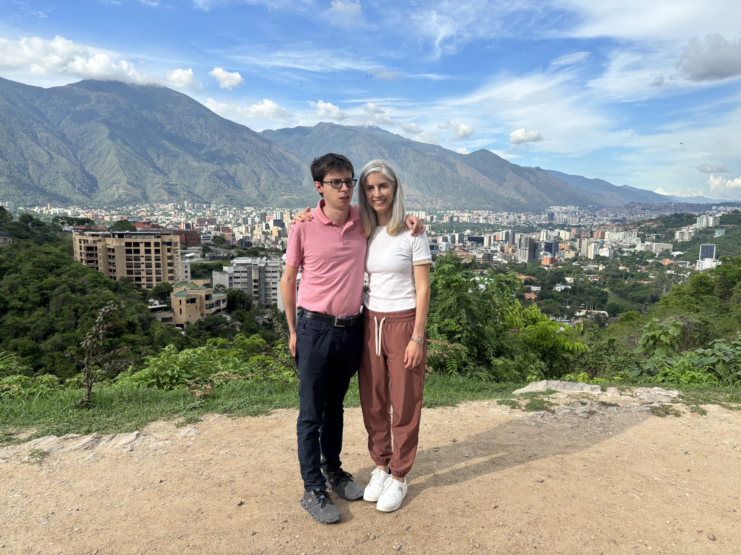 man and woman with city and mountain behind them