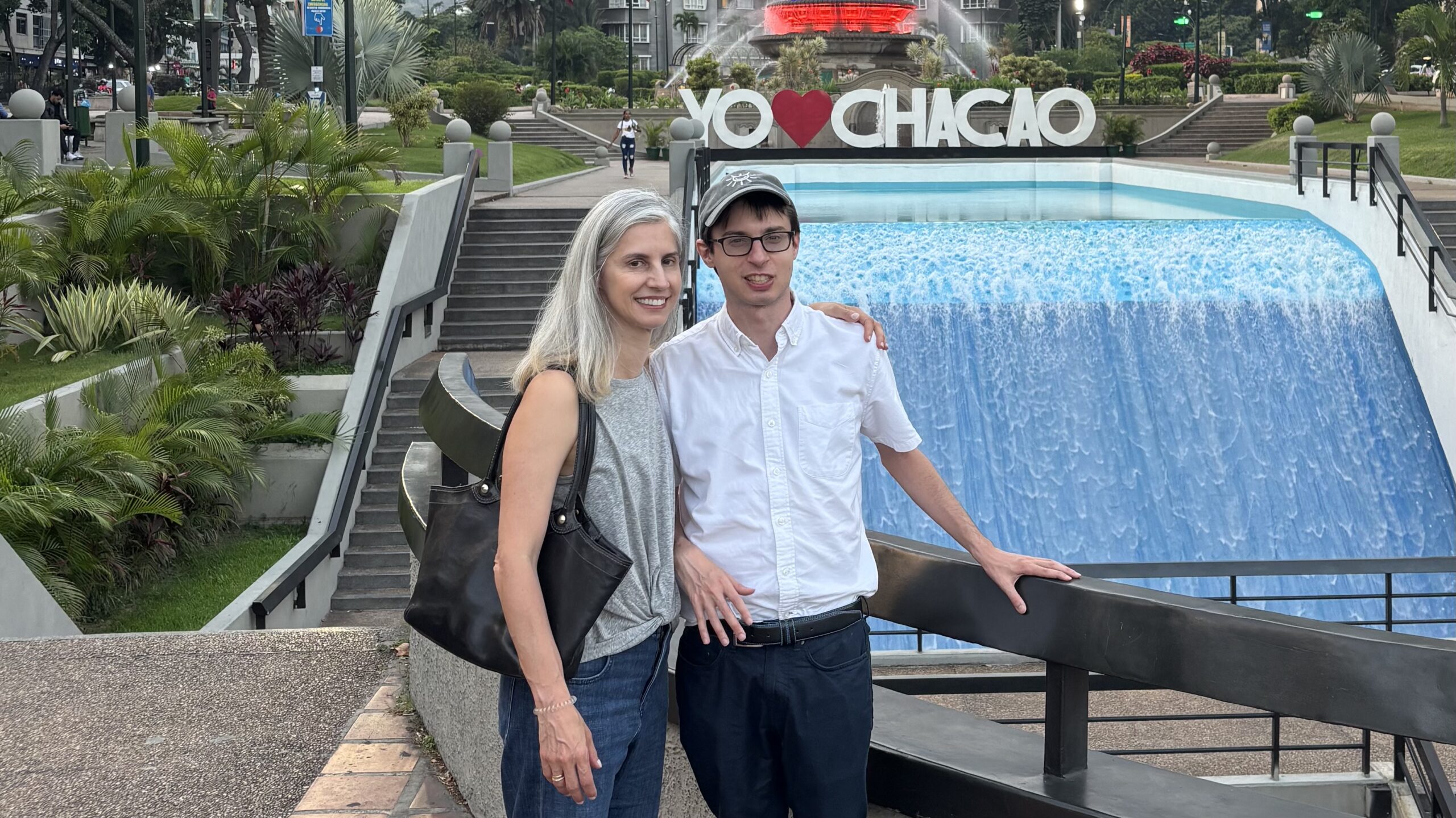 man and woman standing in front of a fountain
