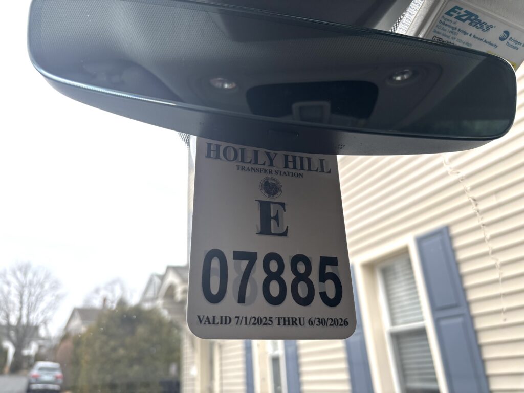 recycling center permit hanging on rearview mirror