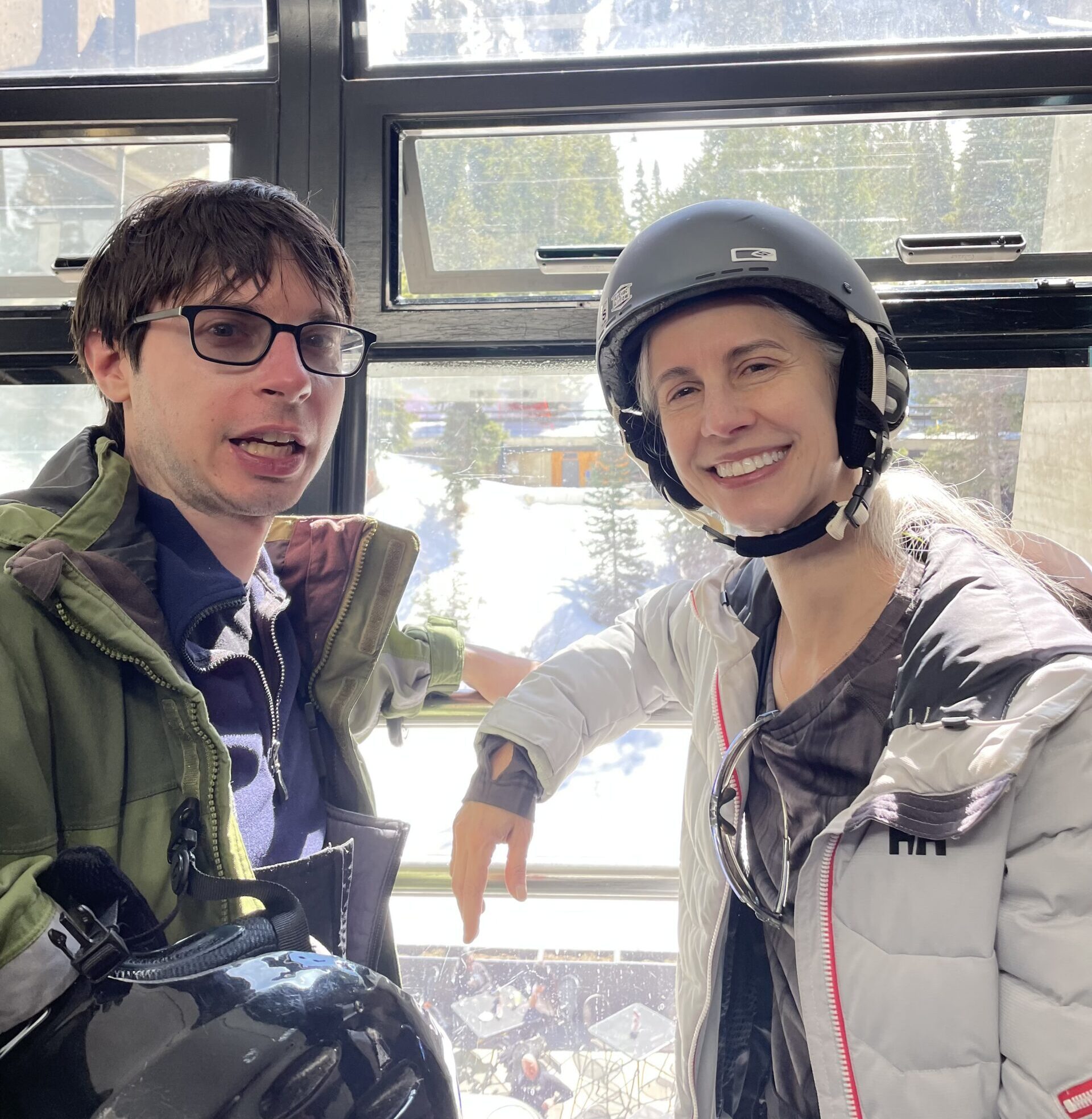 Woman (mother) and man (son) smiling in cable car